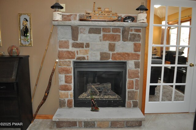 details featuring carpet flooring and a stone fireplace