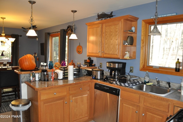 kitchen with stainless steel dishwasher, sink, kitchen peninsula, and hanging light fixtures