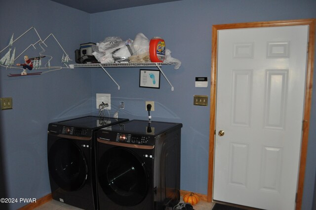 clothes washing area with washer and clothes dryer