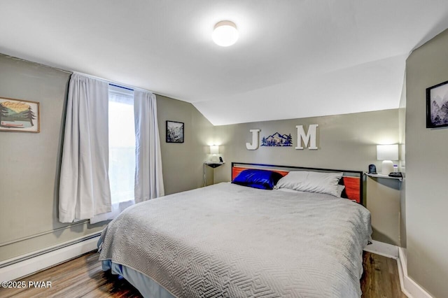 bedroom with baseboards, wood finished floors, lofted ceiling, and a baseboard radiator
