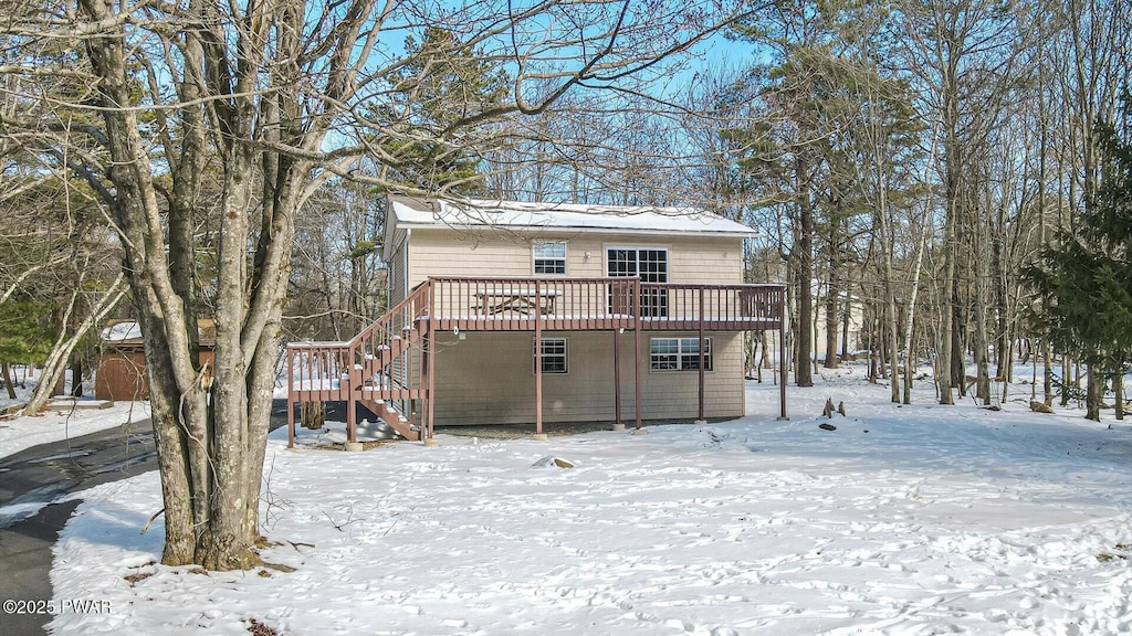 view of front of home with stairway and a wooden deck