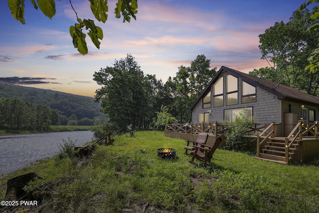 18 Tammany Flts, Damascus, PA 18415 - yard at dusk with an outdoor fire pit and a deck with water view