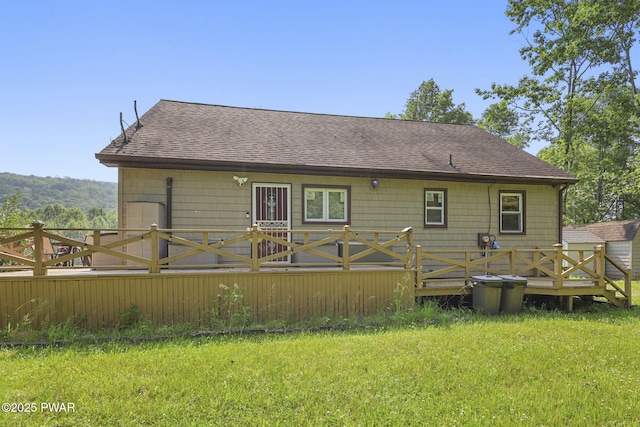 18 Tammany Flts, Damascus, PA 18415 - back of property with a shingled roof, a wooden deck, and a lawn