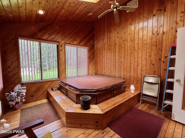 bedroom with wood walls, wood-type flooring, and wooden ceiling