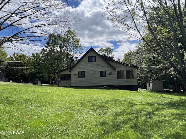 view of home's exterior featuring a yard and a shed