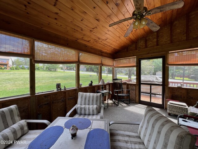 sunroom / solarium with ceiling fan, wooden ceiling, and vaulted ceiling