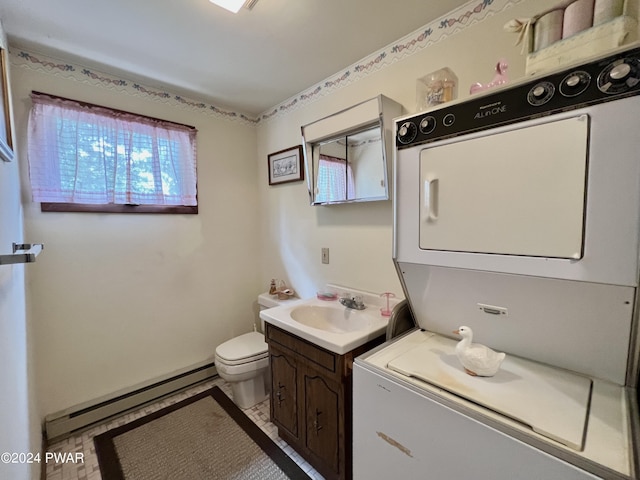 bathroom with stacked washer / drying machine, toilet, vanity, and a baseboard radiator