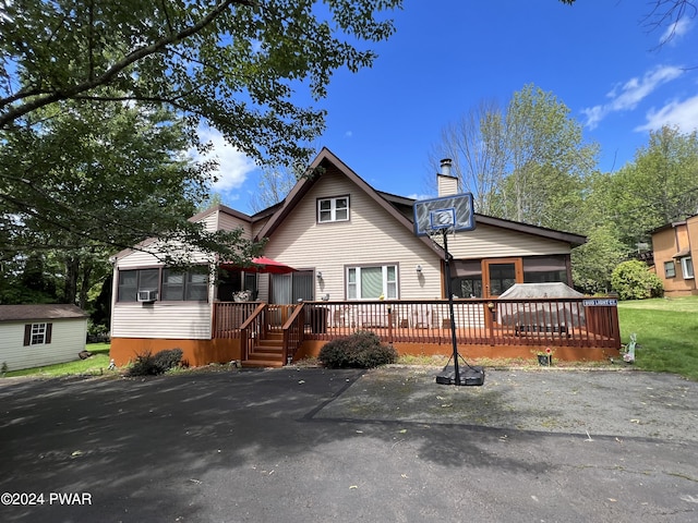 view of front facade with a sunroom and a deck