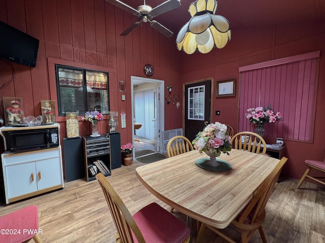 dining area with vaulted ceiling, light hardwood / wood-style flooring, and ceiling fan