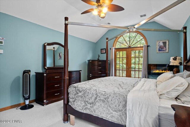 bedroom featuring light carpet, french doors, ceiling fan, and lofted ceiling