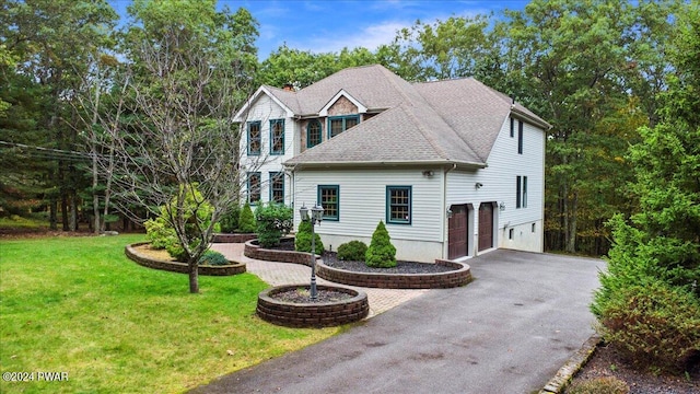 view of front of property with a front lawn and a garage