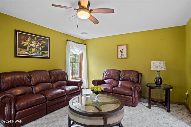 living room with light colored carpet and ceiling fan