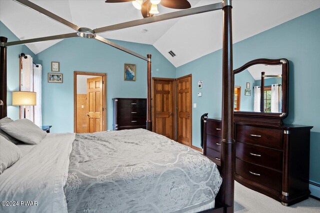 carpeted bedroom with ceiling fan, a baseboard radiator, and vaulted ceiling