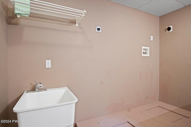 laundry area with hookup for an electric dryer, washer hookup, and sink