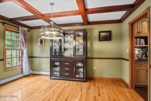 bar with light wood-type flooring, decorative light fixtures, baseboard heating, and coffered ceiling