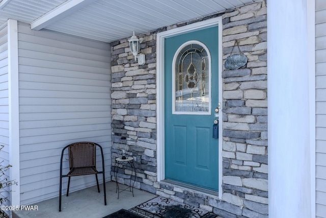 property entrance with stone siding