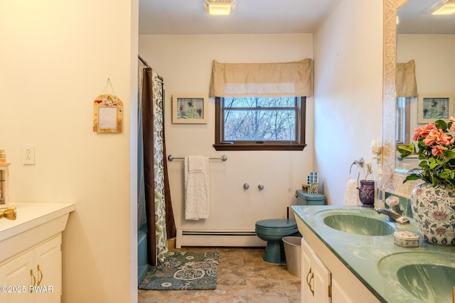 full bathroom featuring double vanity, a baseboard radiator, and a sink