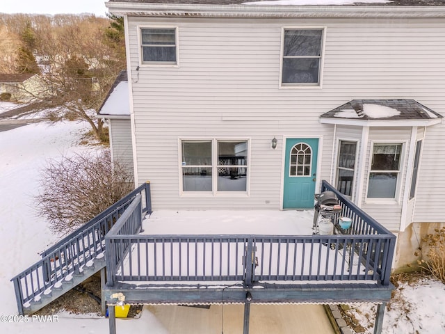 back of property featuring a deck and stairs