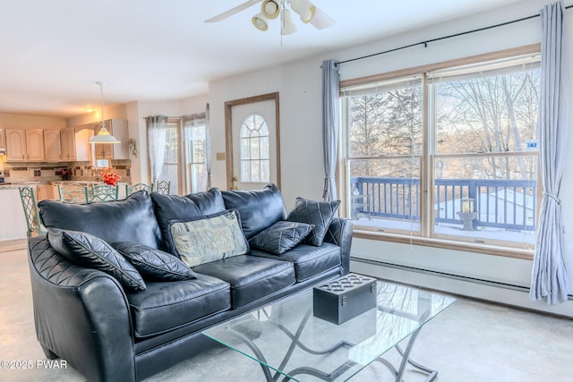 living area featuring a ceiling fan and baseboard heating