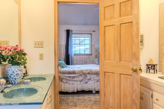 full bathroom featuring double vanity, a sink, and ensuite bathroom