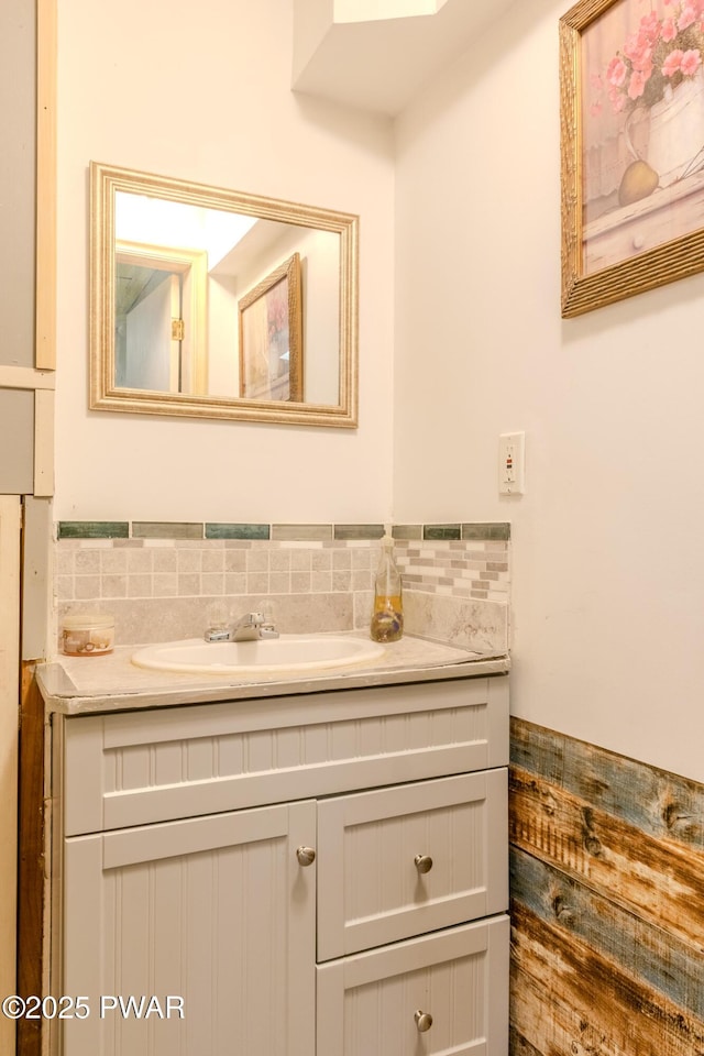 bathroom featuring vanity and decorative backsplash