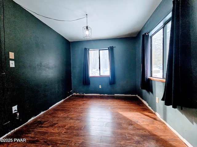 empty room with hardwood / wood-style floors