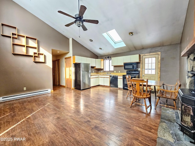 kitchen with ceiling fan, baseboard heating, a skylight, wood-type flooring, and black appliances