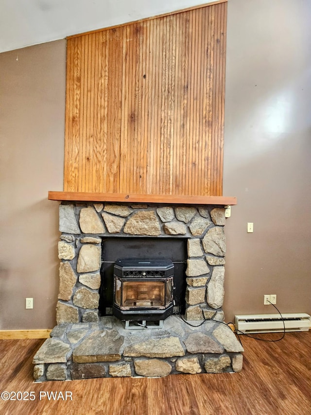 room details featuring hardwood / wood-style flooring, a baseboard radiator, and a wood stove