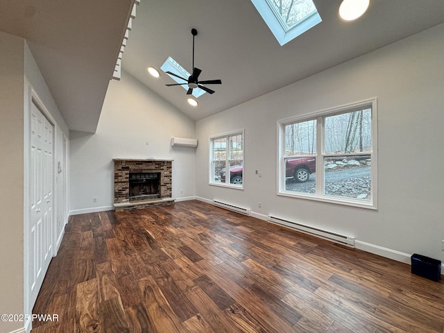 unfurnished living room with a skylight, baseboard heating, a wall mounted air conditioner, wood finished floors, and high vaulted ceiling