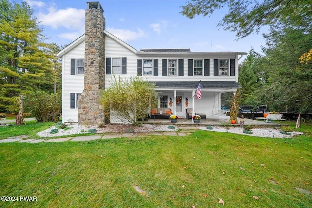 rear view of house featuring a lawn and a patio area