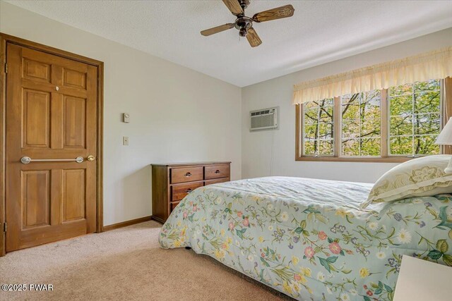 146 Cove Point Cir, Lakeville, PA 18438 - bedroom with light colored carpet, a wall mounted air conditioner, ceiling fan, and baseboards