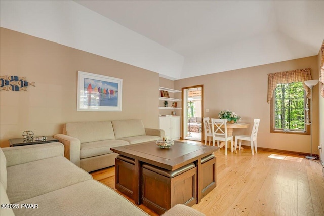 146 Cove Point Cir, Lakeville, PA 18438 - living room with vaulted ceiling, light wood-style flooring, baseboards, and built in features