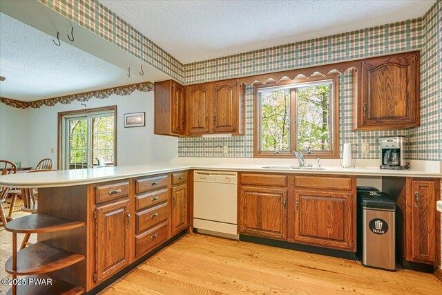 146 Cove Point Cir, Lakeville, PA 18438 - kitchen featuring dishwasher, a sink, a textured ceiling, wallpapered walls, and light wood finished floors