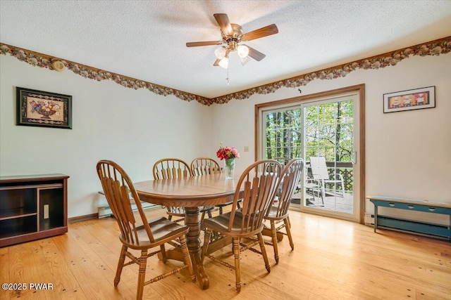 146 Cove Point Cir, Lakeville, PA 18438 - dining space with light wood-style floors, ceiling fan, a textured ceiling, and a baseboard radiator