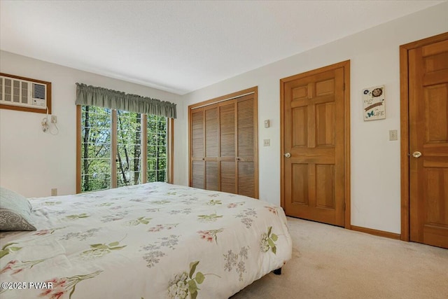 146 Cove Point Cir, Lakeville, PA 18438 - bedroom featuring light carpet, a wall mounted AC, a closet, and baseboards