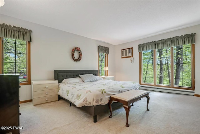 146 Cove Point Cir, Lakeville, PA 18438 - bedroom featuring a baseboard heating unit, light carpet, baseboards, and a wall mounted air conditioner