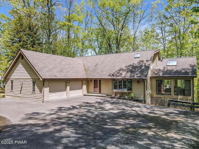 146 Cove Point Cir, Lakeville, PA 18438 - view of front facade featuring roof with shingles, an attached garage, and asphalt driveway