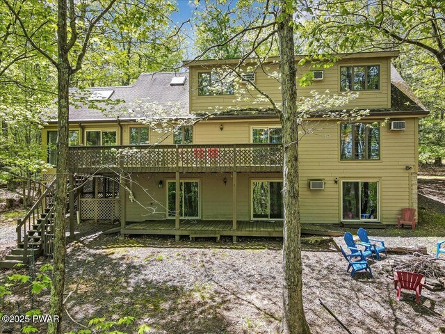 146 Cove Point Cir, Lakeville, PA 18438 - rear view of property featuring a fire pit, a wooden deck, stairs, and a patio area