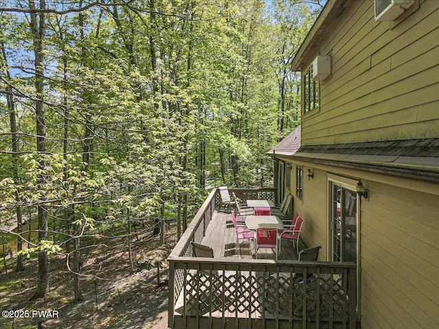 146 Cove Point Cir, Lakeville, PA 18438 - wooden deck featuring a view of trees and outdoor dining space