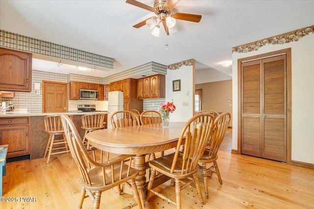 146 Cove Point Cir, Lakeville, PA 18438 - dining area featuring light wood-type flooring, a ceiling fan, and a textured ceiling
