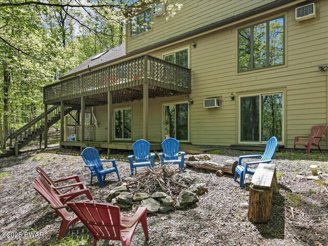 146 Cove Point Cir, Lakeville, PA 18438 - back of property featuring stairs, a deck, an outdoor fire pit, and an AC wall unit