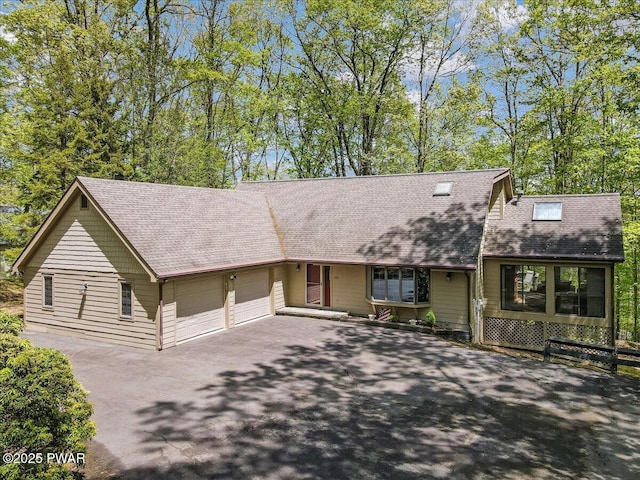 146 Cove Point Cir, Lakeville, PA 18438 - view of front facade with roof with shingles, asphalt driveway, and an attached garage