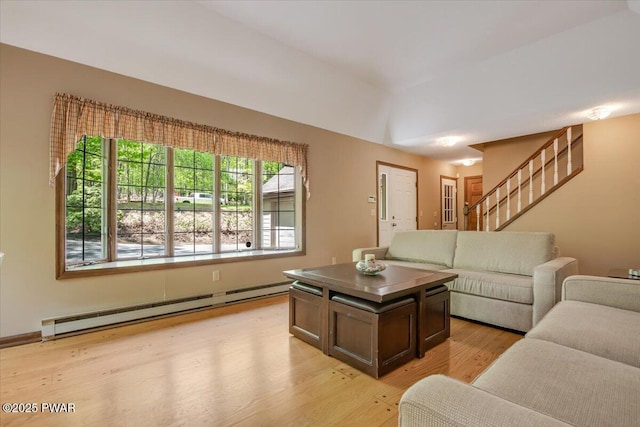 146 Cove Point Cir, Lakeville, PA 18438 - living room featuring baseboard heating, light wood-style flooring, and stairway
