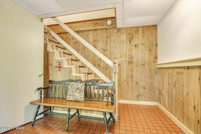 146 Cove Point Cir, Lakeville, PA 18438 - staircase featuring wood walls, baseboards, and a drop ceiling