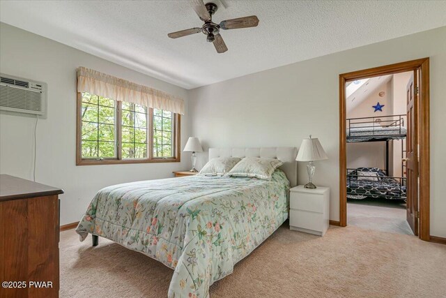 146 Cove Point Cir, Lakeville, PA 18438 - bedroom featuring carpet flooring, baseboards, a wall mounted air conditioner, ceiling fan, and a textured ceiling