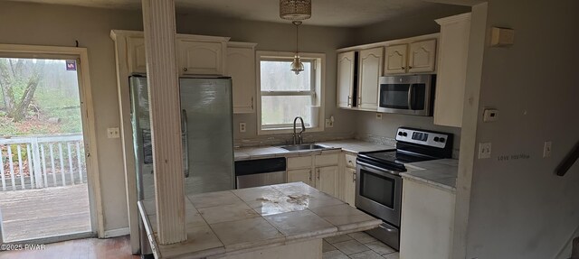 171 Flatbrook Way, Milford, PA 18337 - kitchen with decorative light fixtures, appliances with stainless steel finishes, a sink, and tile counters