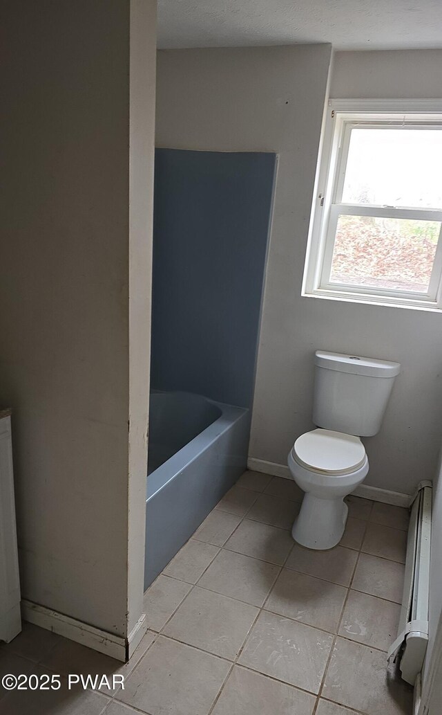 171 Flatbrook Way, Milford, PA 18337 - full bathroom with a bathing tub, tile patterned flooring, toilet, a baseboard radiator, and baseboards
