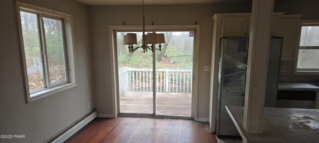 171 Flatbrook Way, Milford, PA 18337 - dining space with plenty of natural light, a chandelier, wood finished floors, and baseboard heating