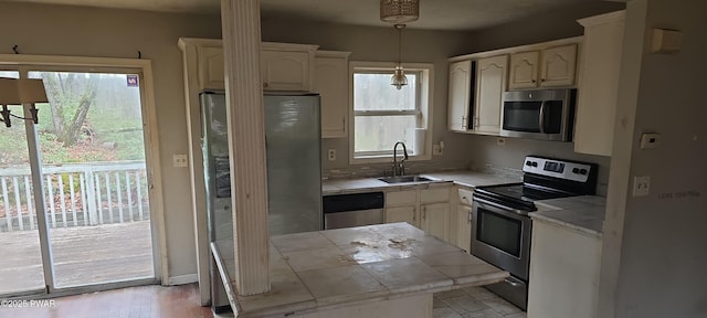 171 Flatbrook Way, Milford, PA 18337 - kitchen with tile counters, decorative light fixtures, light wood-style floors, stainless steel appliances, and a sink