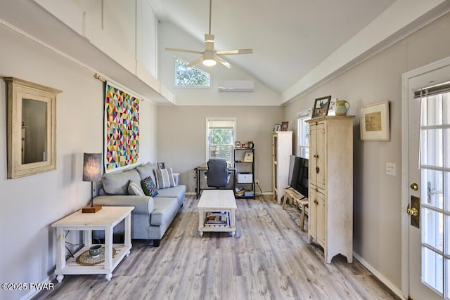 living area featuring baseboards, ceiling fan, a wall unit AC, light wood-style floors, and high vaulted ceiling